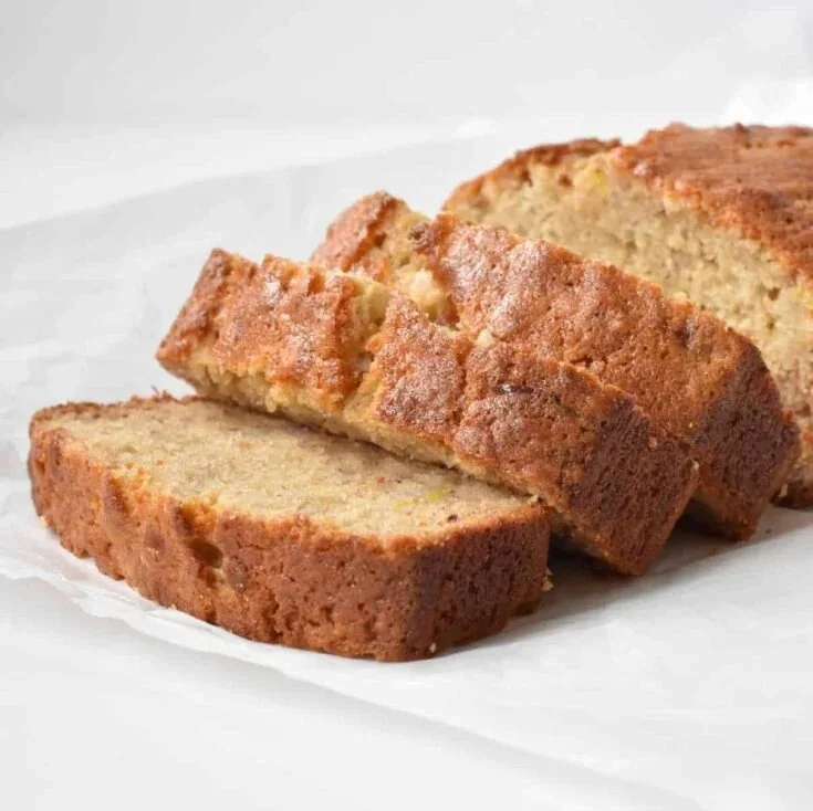 Delicious homemade banana bread sliced on a wooden board