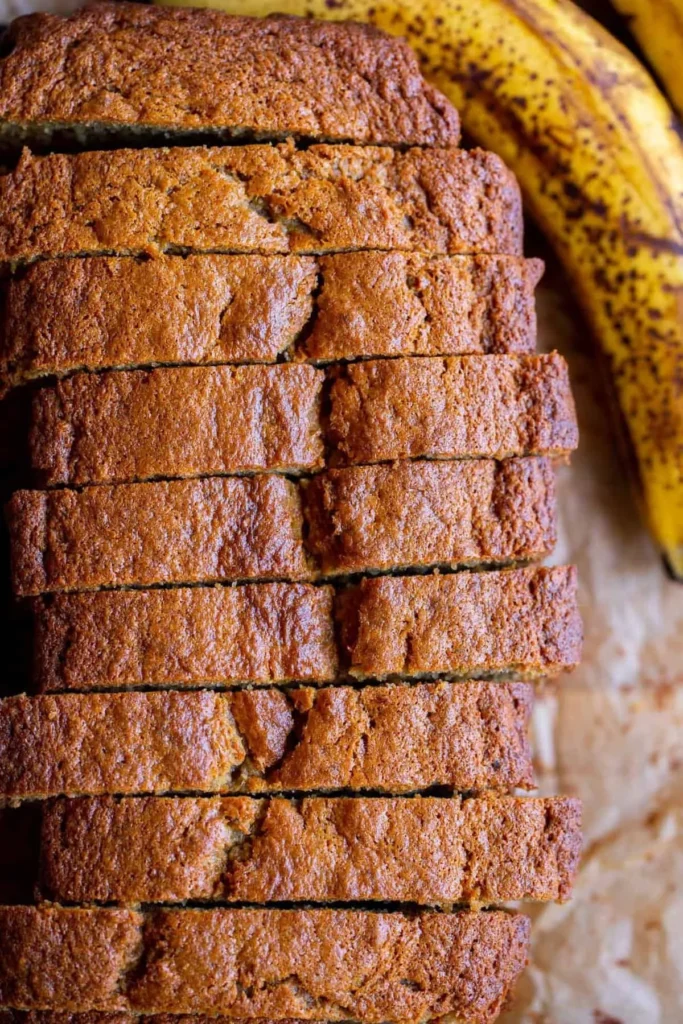 Loaf of homemade banana bread, freshly baked and sliced.